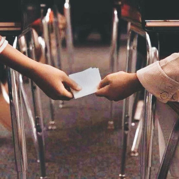 This may contain: two people reaching out their hands to each other in front of some chairs with papers on them