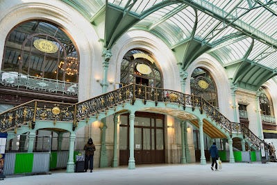 Paris train station entrantrance at Gare de Lyon, a glass and steel girder roof, and hihgoy ornanate images of the decoration in the restaurant.