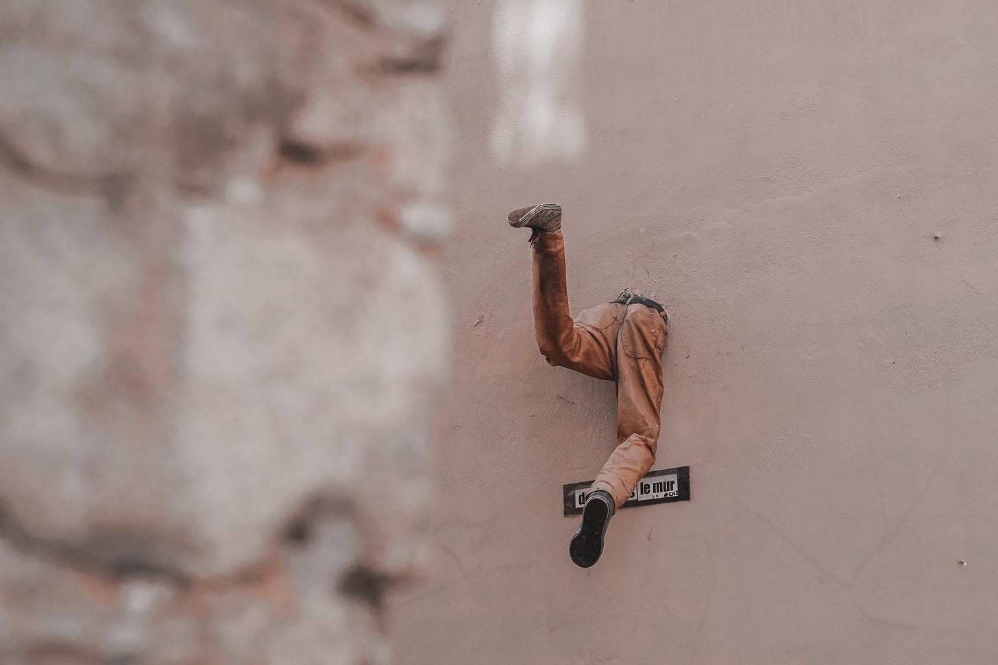 Man stuck in the wall trying to escape Man stuck in the wall trying to escape