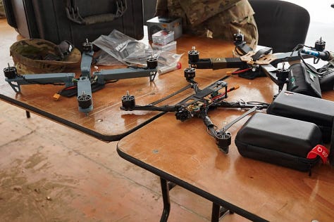 U.S. Army soldiers training with Titan V3 counter-unmanned aerial system technology in a wooded Latvian environment during the multinational Saber Strike 26 exercise.