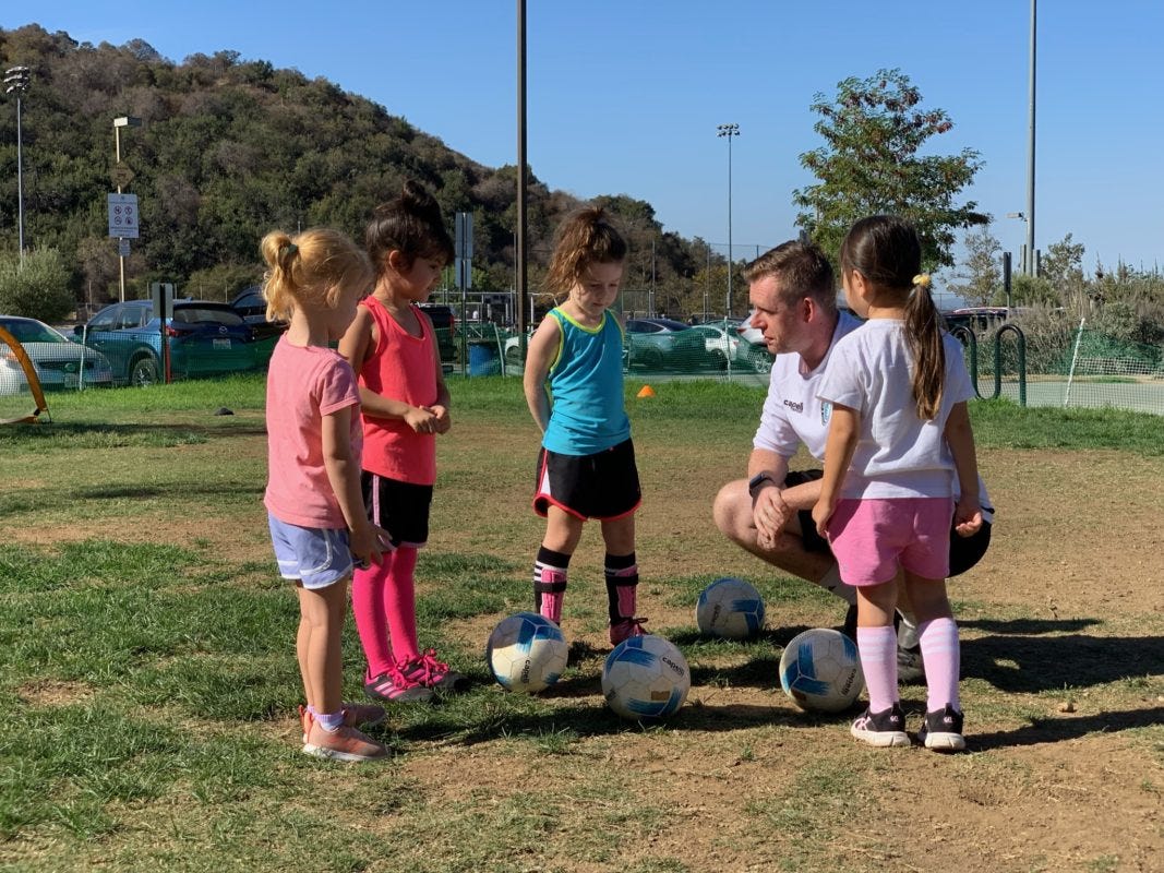 kids soccer class with their coach. Girls soccer class 
