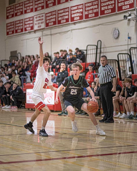 Five pictures of CVU boys basketball players in various stages of leaping and shooting with the ball. White uniforms with red lettering.