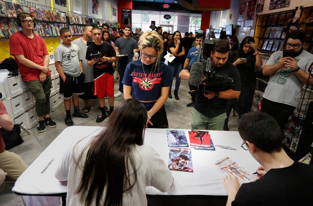A large group of fans gather to get autographs from Steve Aoki during a comic book signing of h … A large group of fans gather to get autographs from Steve Aoki during a comic book signing of h …