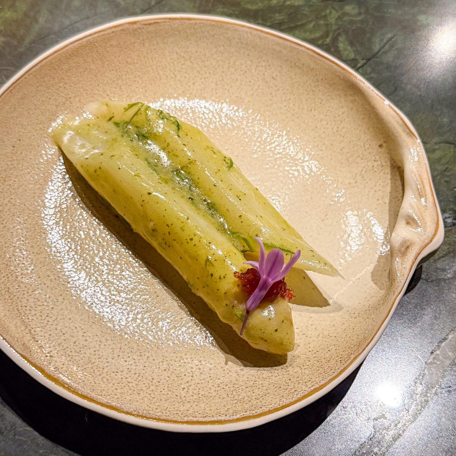 White asparagus spears with shellfish sauce and fermented chili jam at Mantra restaurant