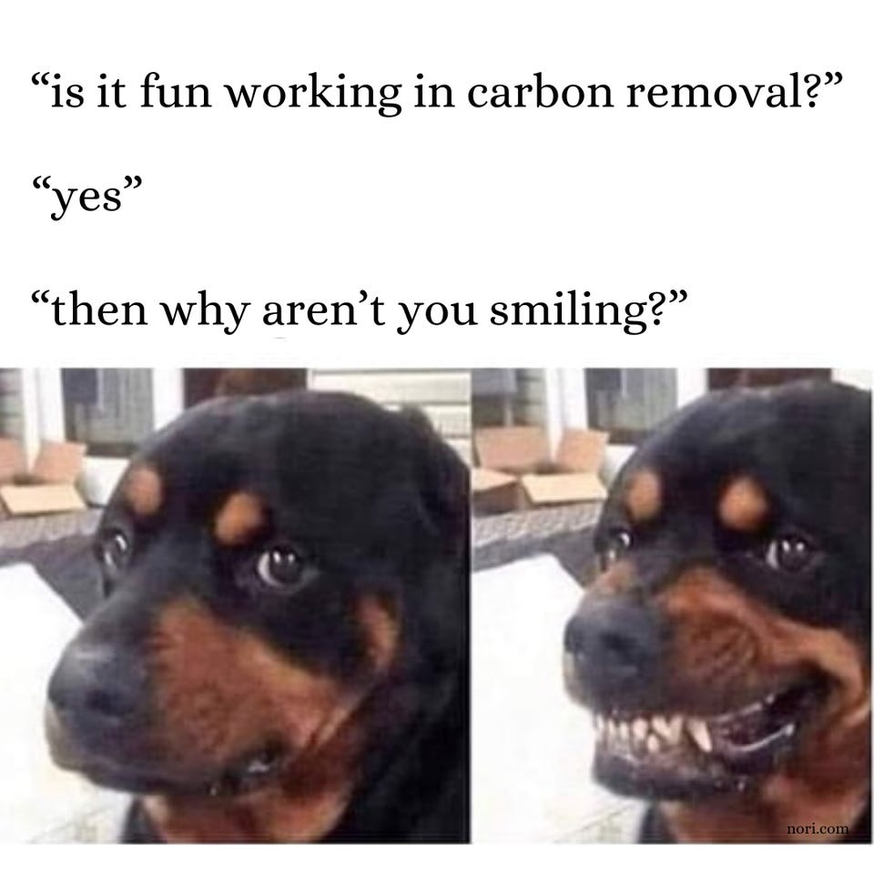 Two photos of a Rottweiler under the text "'is it fun working in carbon removal?' 'yes' 'then why aren't you smiling?'" The dog looks glum in the first photo and bares its teeth in a forced grin in the second.