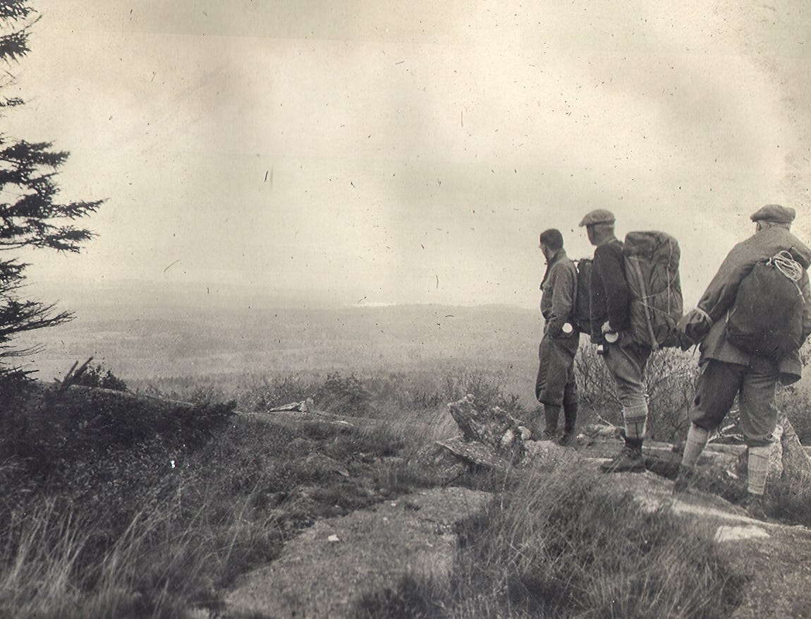 Three hikers looking at Mountain