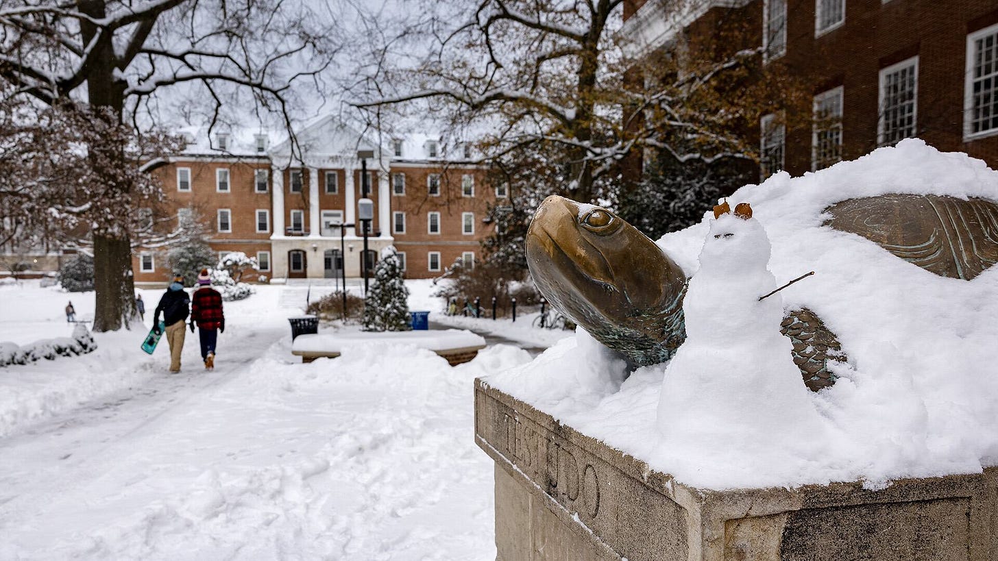 Testudo statue covered in snow, with tiny snowman Testudo statue covered in snow, with tiny snowman