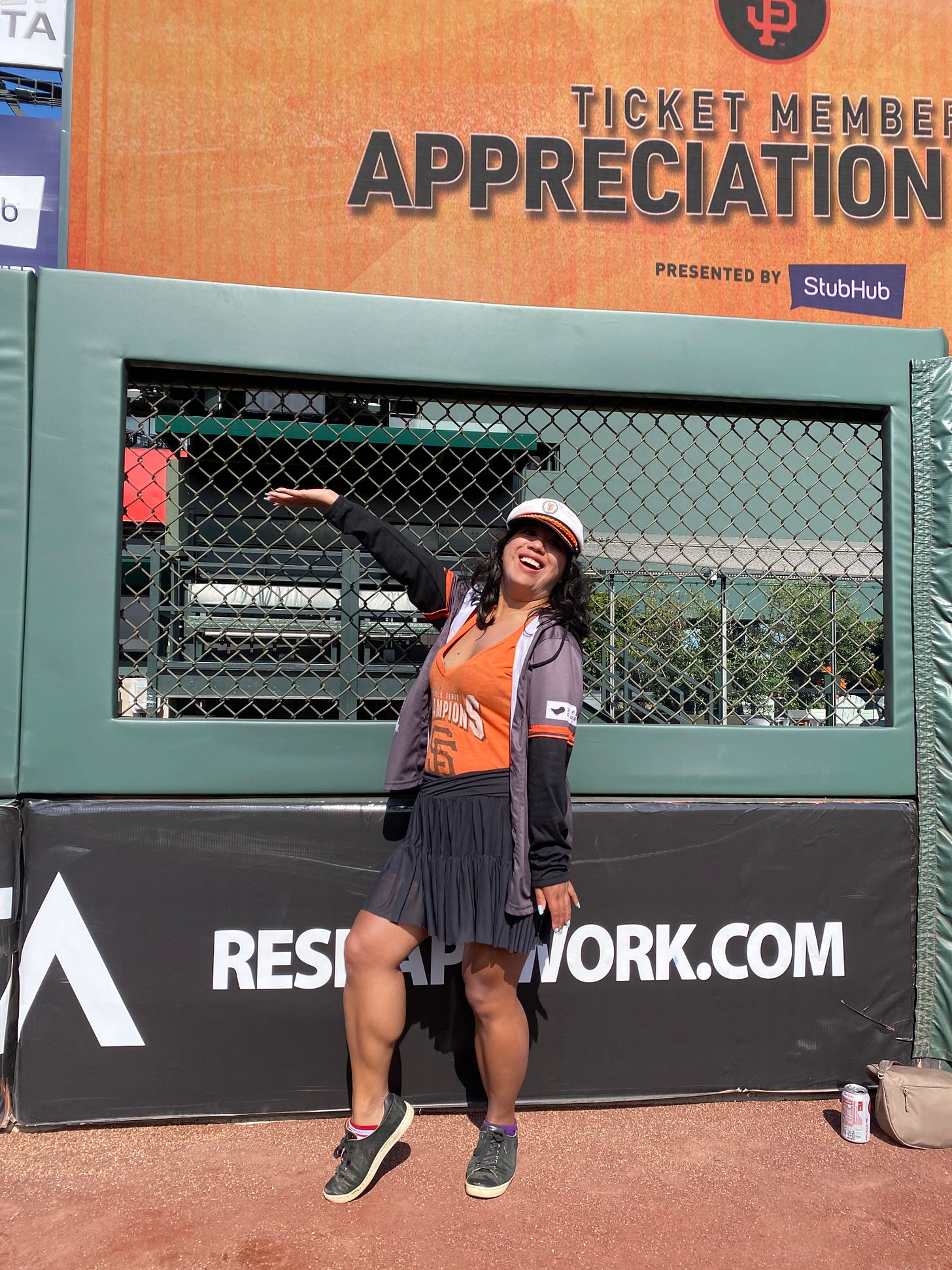 Goofy SF Giants fan in sailor hat on the field at Oracle Park