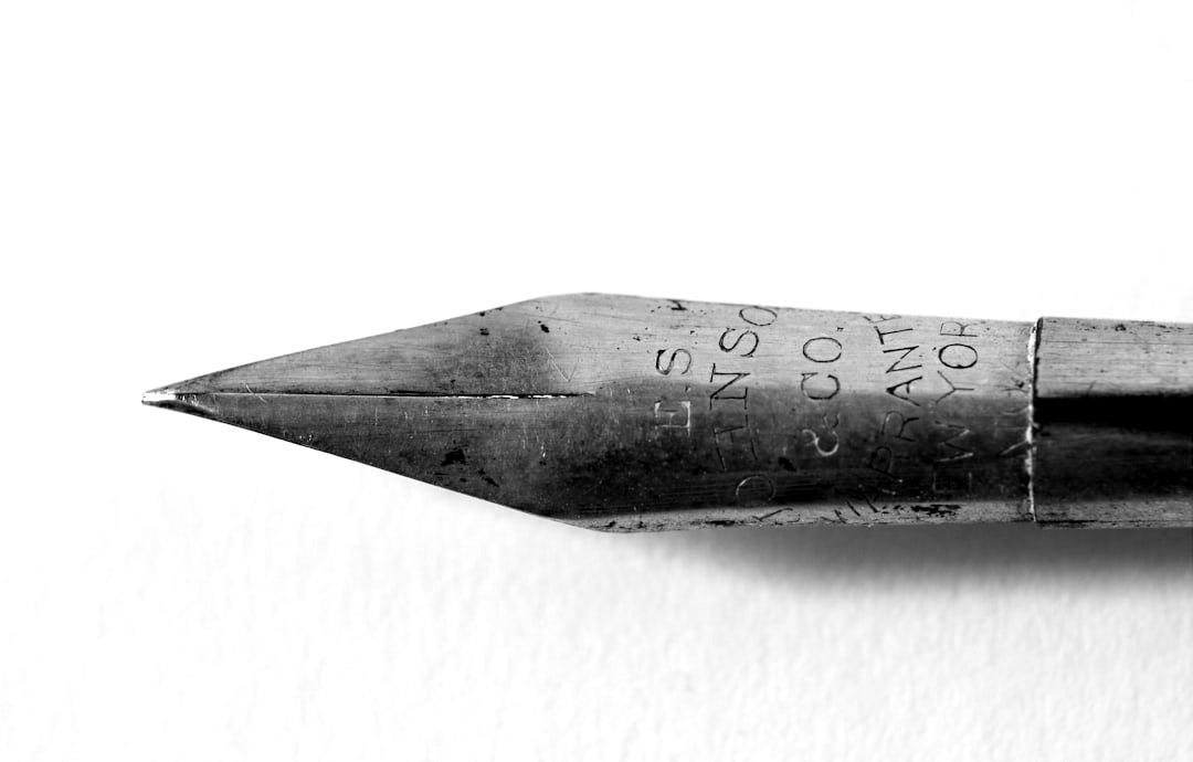 closeup photo of gold fountain pen