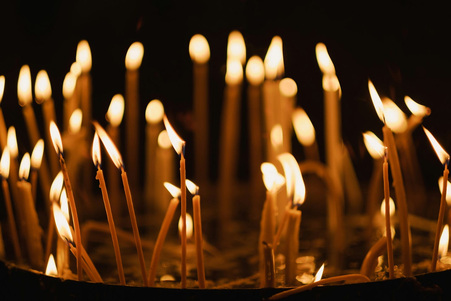 A group; of lit candles all placed in a circle. 