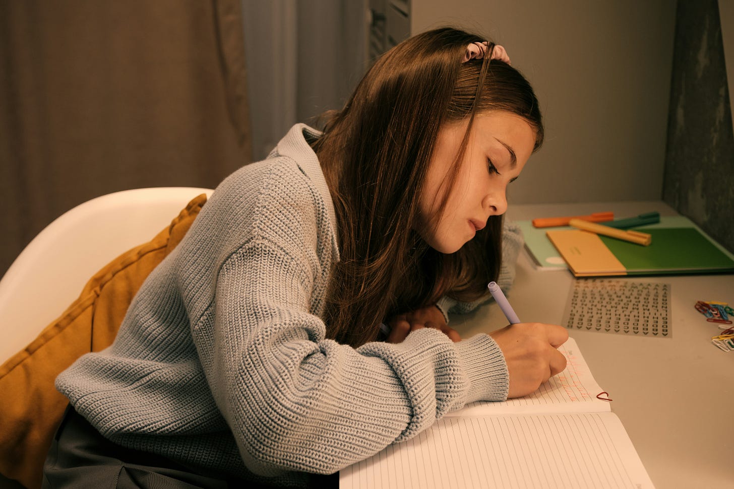 young girl writing in her diary