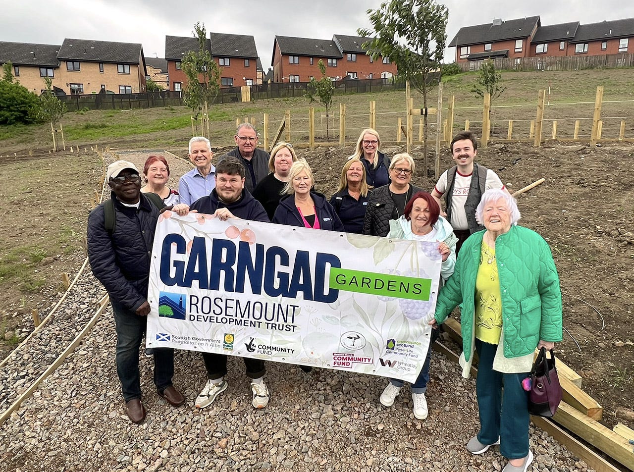 May be an image of 10 people and text that says "Scortish everneer GARNGAD GARDENS ROSEMOUNT DEVEL DEVELOPMENT TRUST FLNDMUNDT COMMUNITY COMMUNITY FUND icotind Nfand V Craatey Group Ahatley"