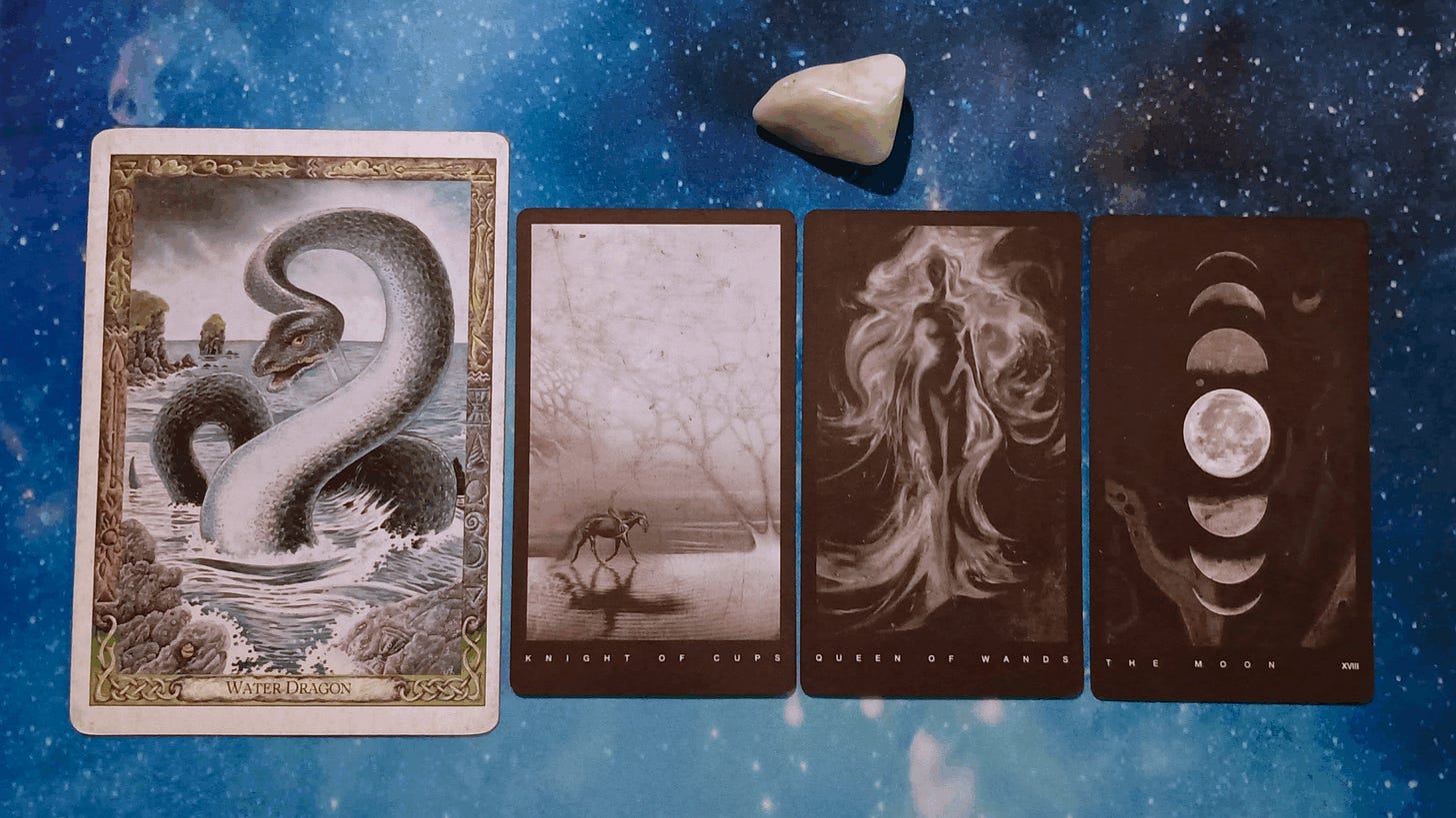 New Moon Magic: Your July 2025 Pick-a-Card Tarot Reading, pile 3 - Jade (light green) stone and 4 cards on a starry blue background