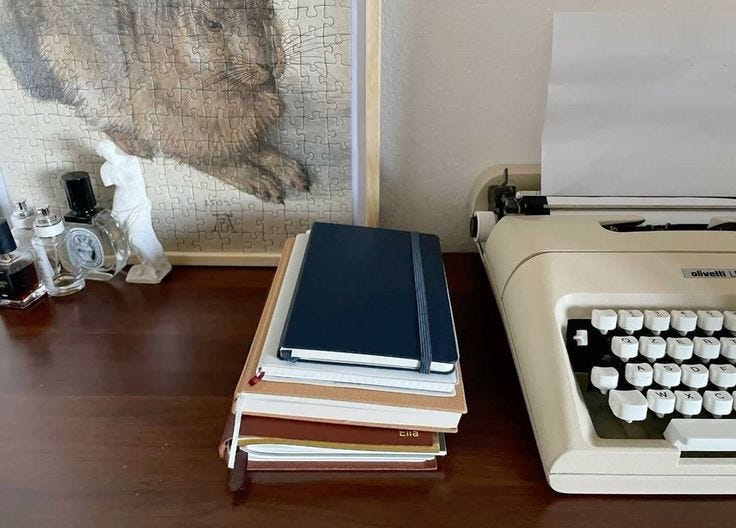 This may contain: an old fashioned typewriter sitting on top of a desk next to books and other items This may contain: an old fashioned typewriter sitting on top of a desk next to books and other items