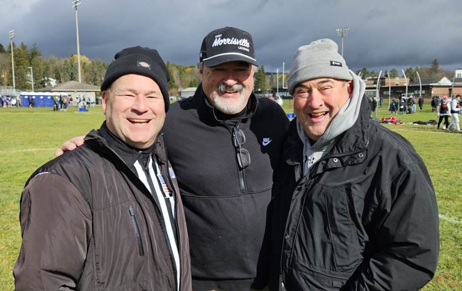 A group of men standing together

AI-generated content may be incorrect.