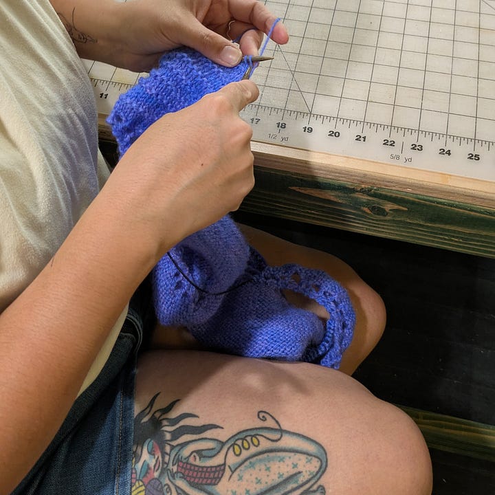 L: an in progress patchwork vest with a secret 'Steelie' for a grateful dead fan, R: a person knitting with a mermaid knitting tattoo