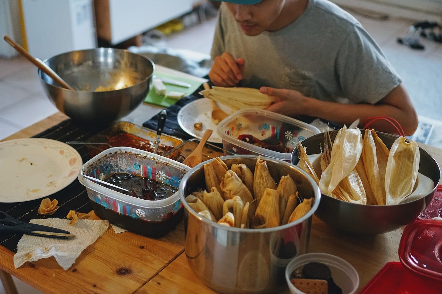 Kevin at the kitchen table constructing tamales