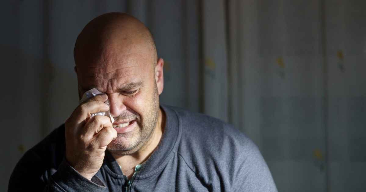Middle aged man crying at home