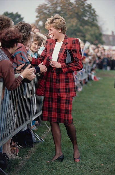 Diana, Princess of Wales meets the public during a visit to Tenterden in Kent, 18th October 1990. She is wearing a red and black checked suit by...
