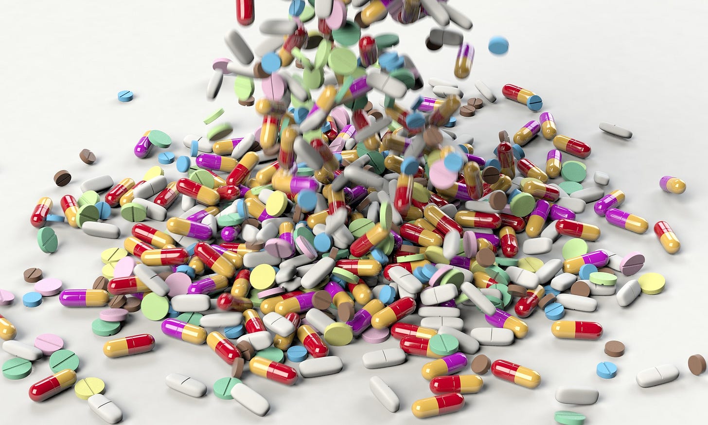Pills are raining down onto a white countertop