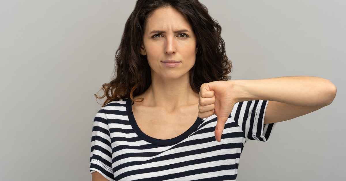 dissatisfied woman gesturing thumbs down