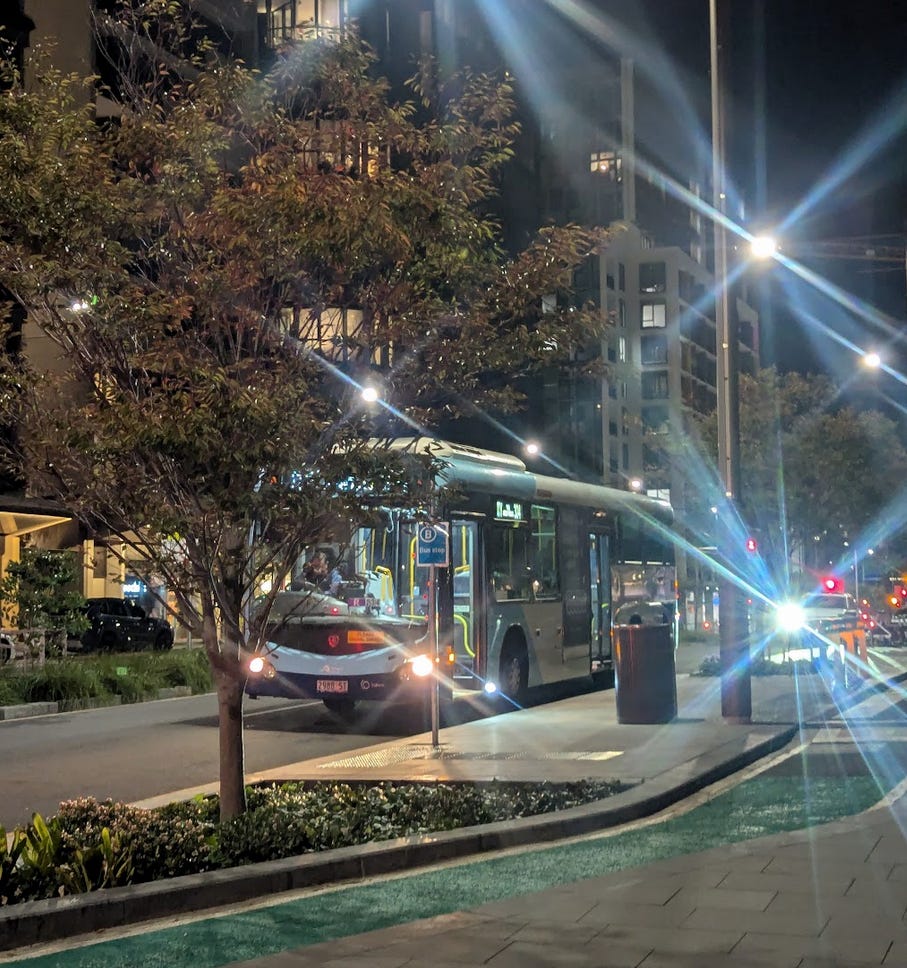bus stopping at a laminated piece of paper taped to a pole