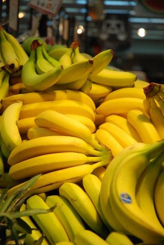 A pile of bananas in a shop. "bananas!" by ntsiro is licensed under CC BY-NC-SA 2.0 