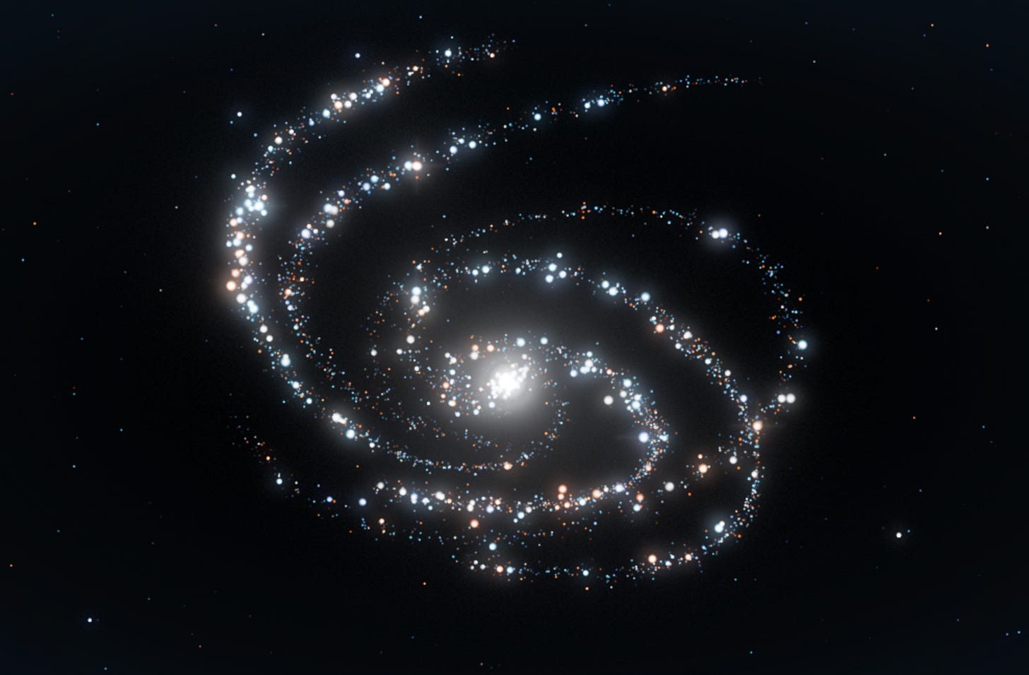 A luminous spiral of blue, white, and amber stars against a dark background. A luminous spiral of blue, white, and amber stars against a dark background.