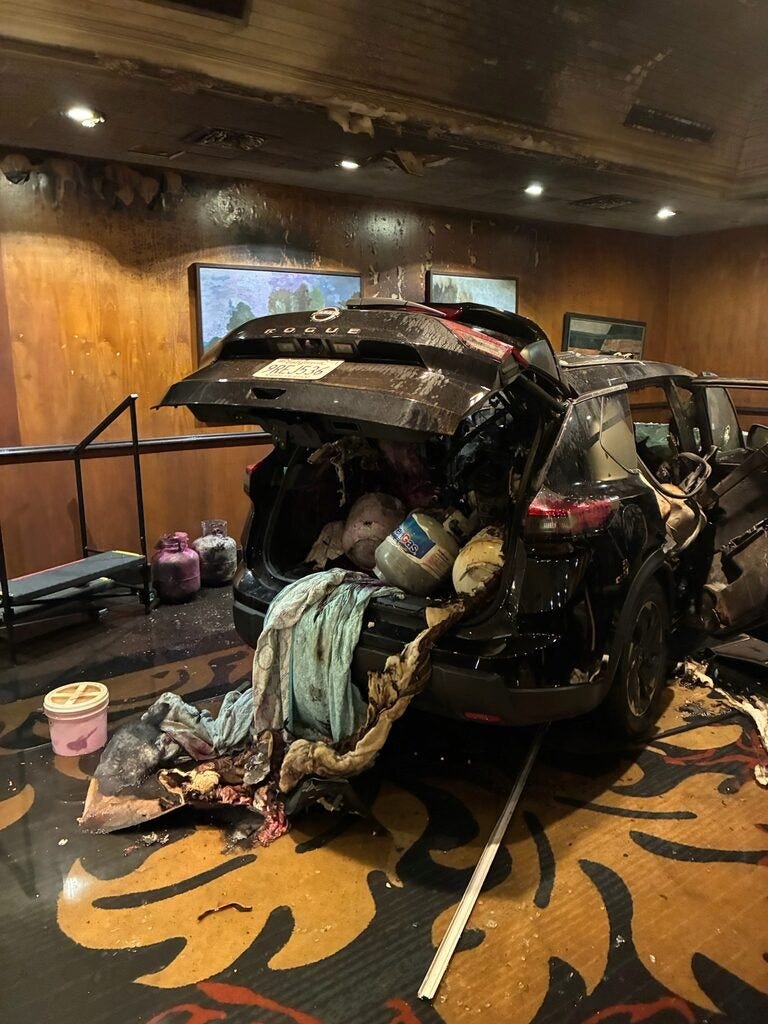Vehicle filled with propane tanks inside building 