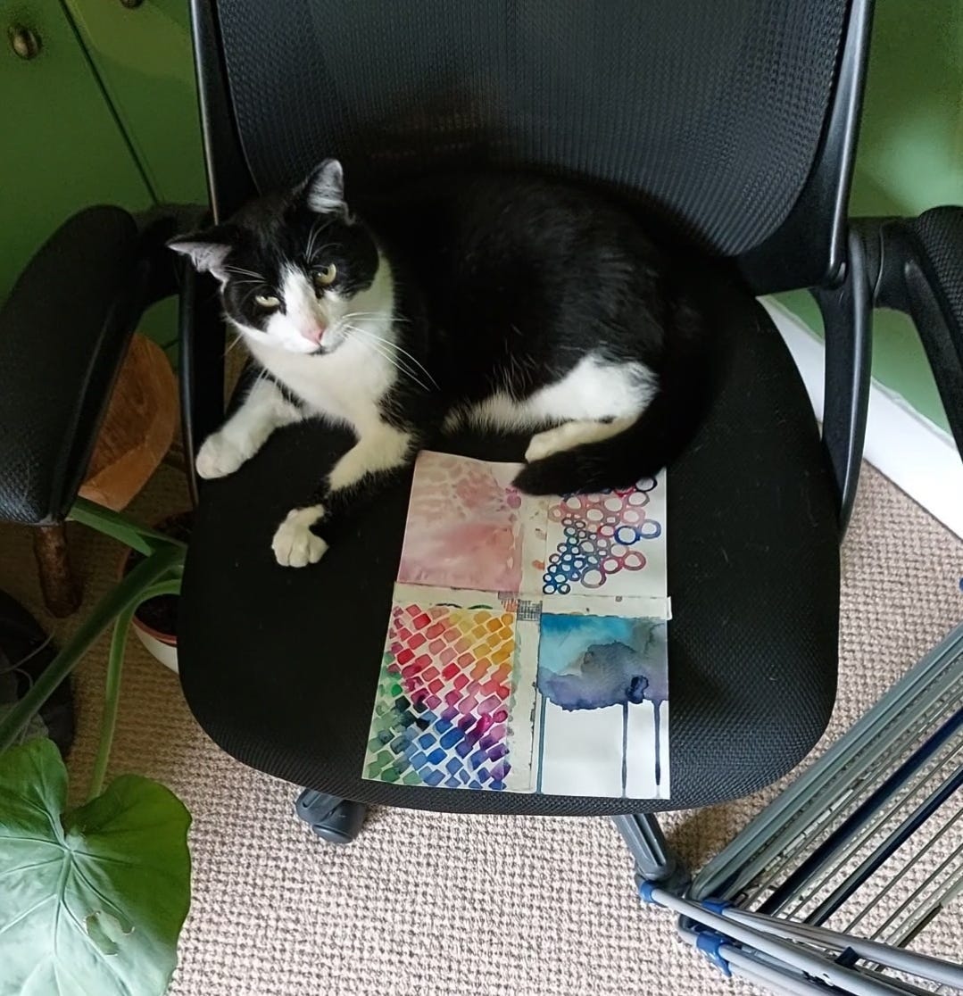 Victor is on a chair sharing space with a watercolor painting. Victor is on a chair sharing space with a watercolor painting.