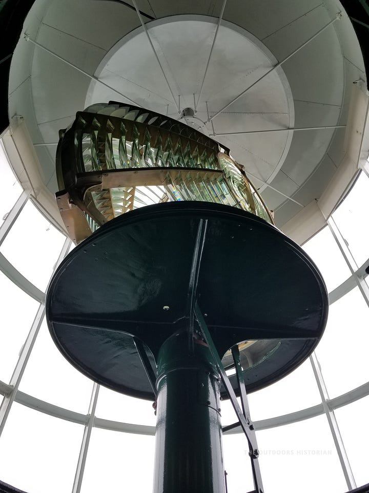 A split image showing the iconic Split Rock Lighthouse perched on a cliff in the distance, and a second interior shot looking up into the intricate glass prisms of the massive Fresnel lens.