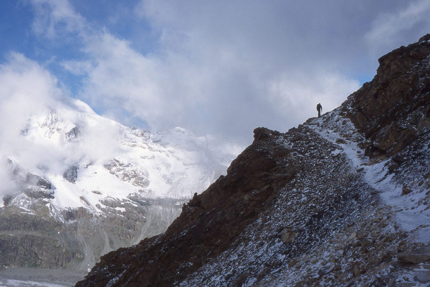 snow/ice covered path, cloud, mountains