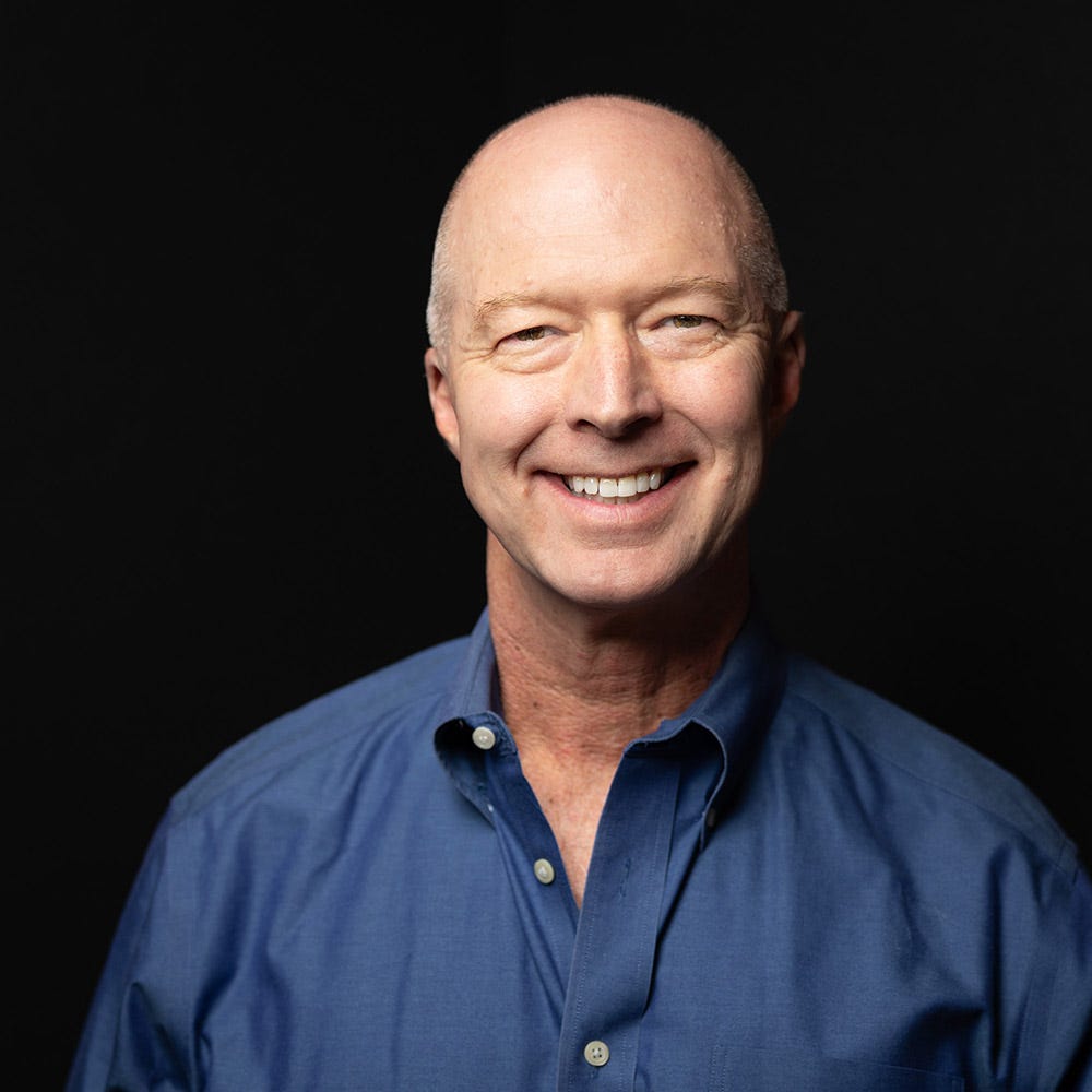 Self-portrait of photographer Michael Kloth, wearing a blue shirt in front of a dark background. Self-portrait of photographer Michael Kloth, wearing a blue shirt in front of a dark background.