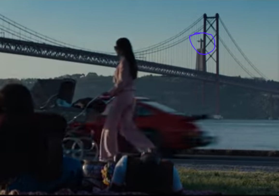 Scene of bridge in Lisbon, Portugage, as a statue of Jesus in the background Scene of bridge in Lisbon, Portugage, as a statue of Jesus in the background