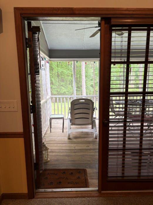 Photo of the door opened to the porch. Photo is from inside the great room. My white reading chair and green glass-topped table are visible in the photo. Photo of the door opened to the porch. Photo is from inside the great room. My white reading chair and green glass-topped table are visible in the photo.