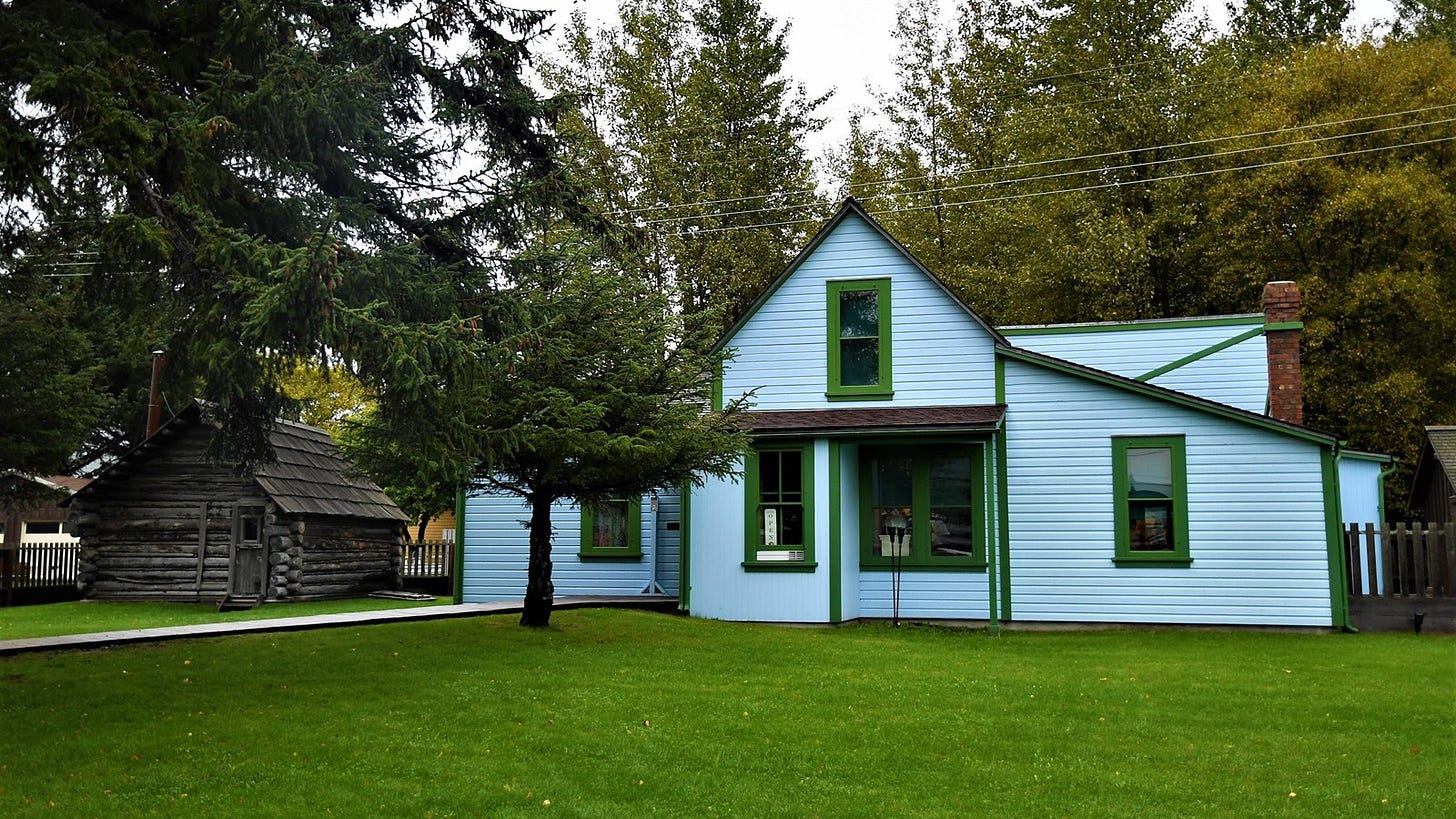 Original log cabin and the newer home of Captain William Moore in Skagway, Alaska.
