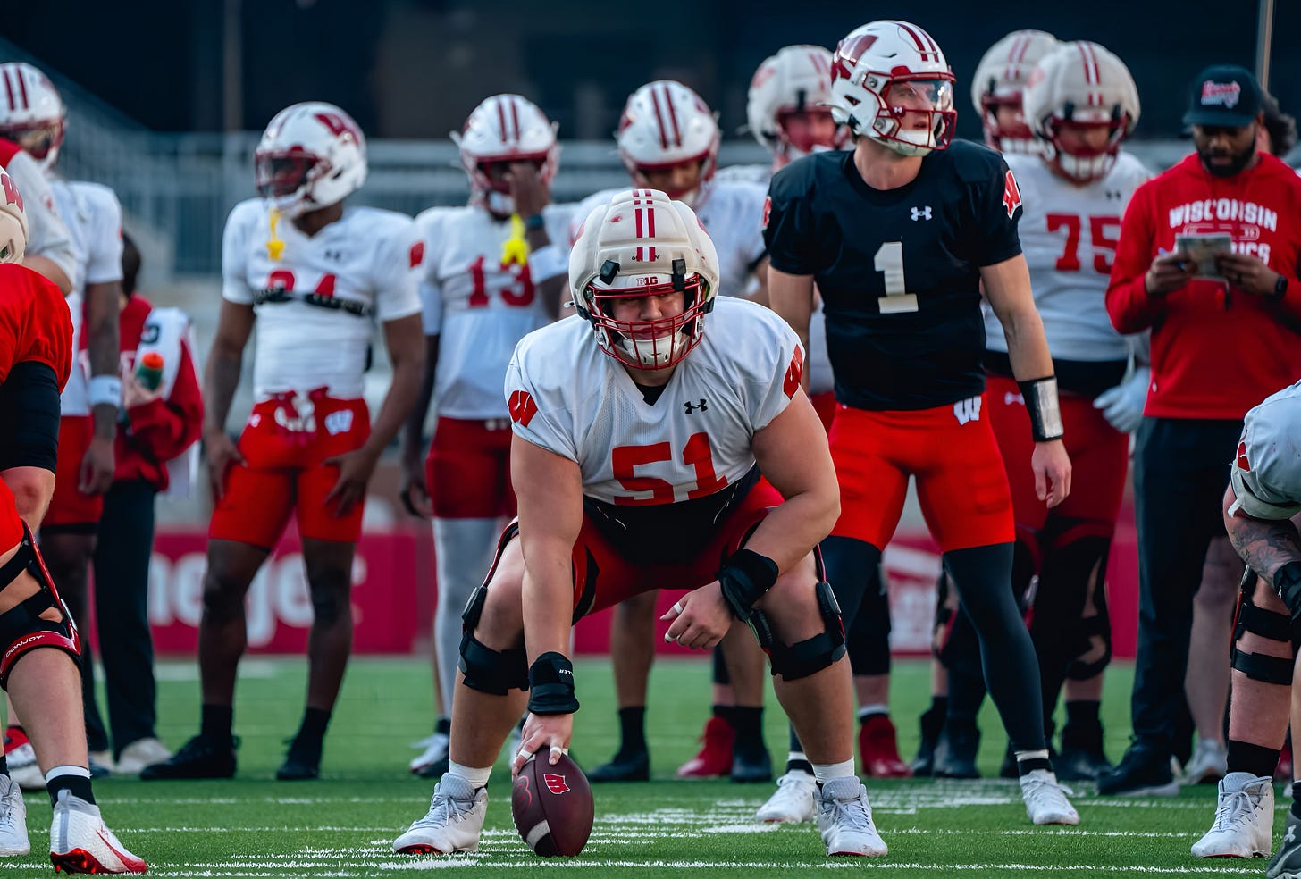 Wisconsin Badgers center Austin Kawecki snaps the ball to quarterback Colton Joseph during spring practice. Photo credit: UW Athletics.