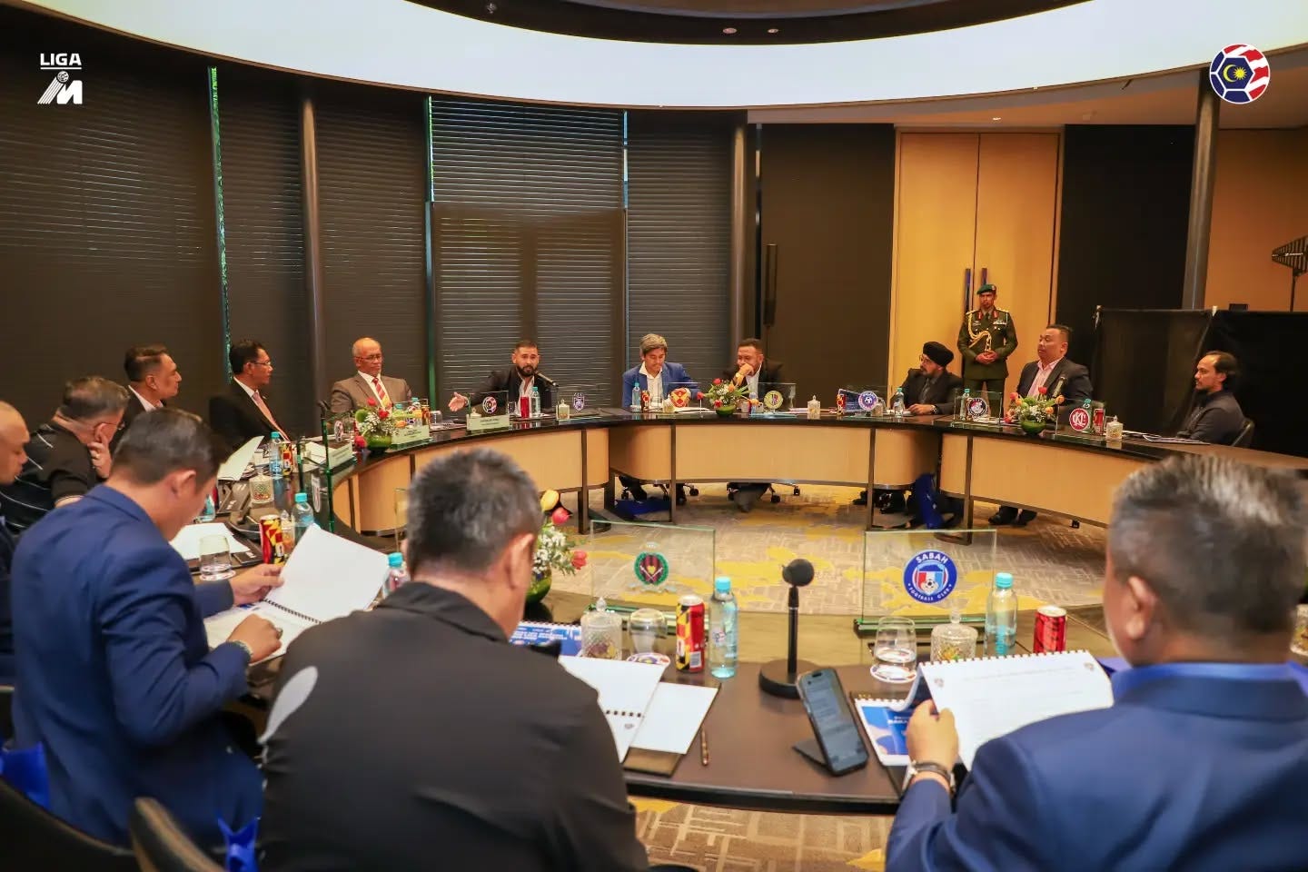 May be an image of one or more people, newsroom and text