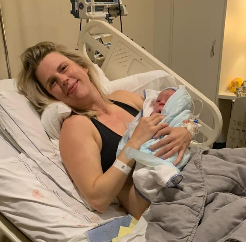 mother with newborn in hospital bed