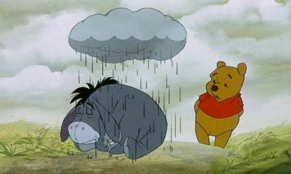 Pooh comforts Eeyore in the rain