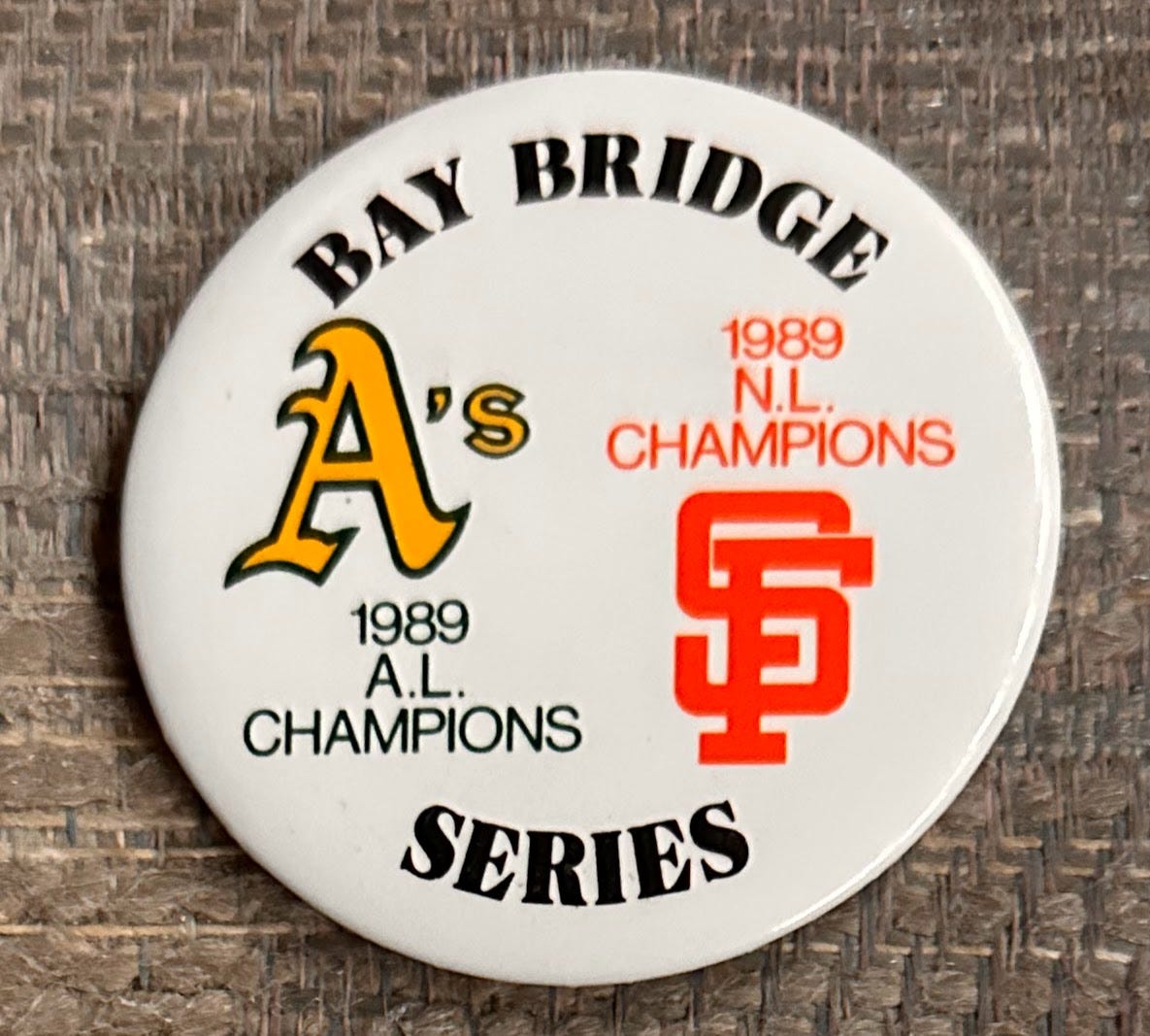 Pinback button reads "Bay Bridge Series, A's logo 1989 AL Champions, Giants logo 1989 NL Champions