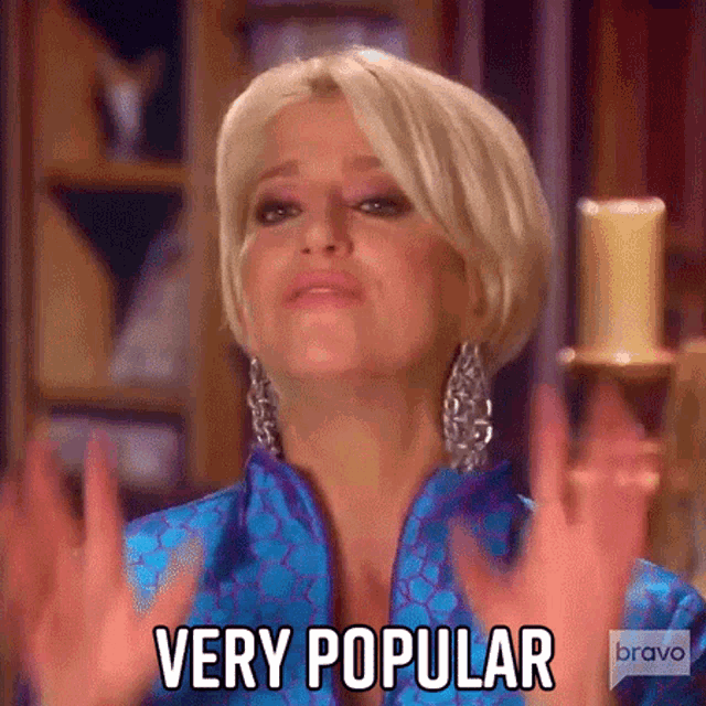 a woman in a blue jacket is making a very popular gesture . a woman in a blue jacket is making a very popular gesture .