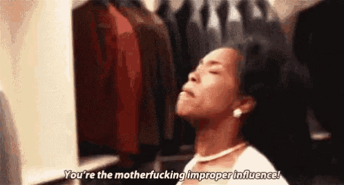 a woman is standing in a closet and saying `` you 're the motherfucking improper influence '' .