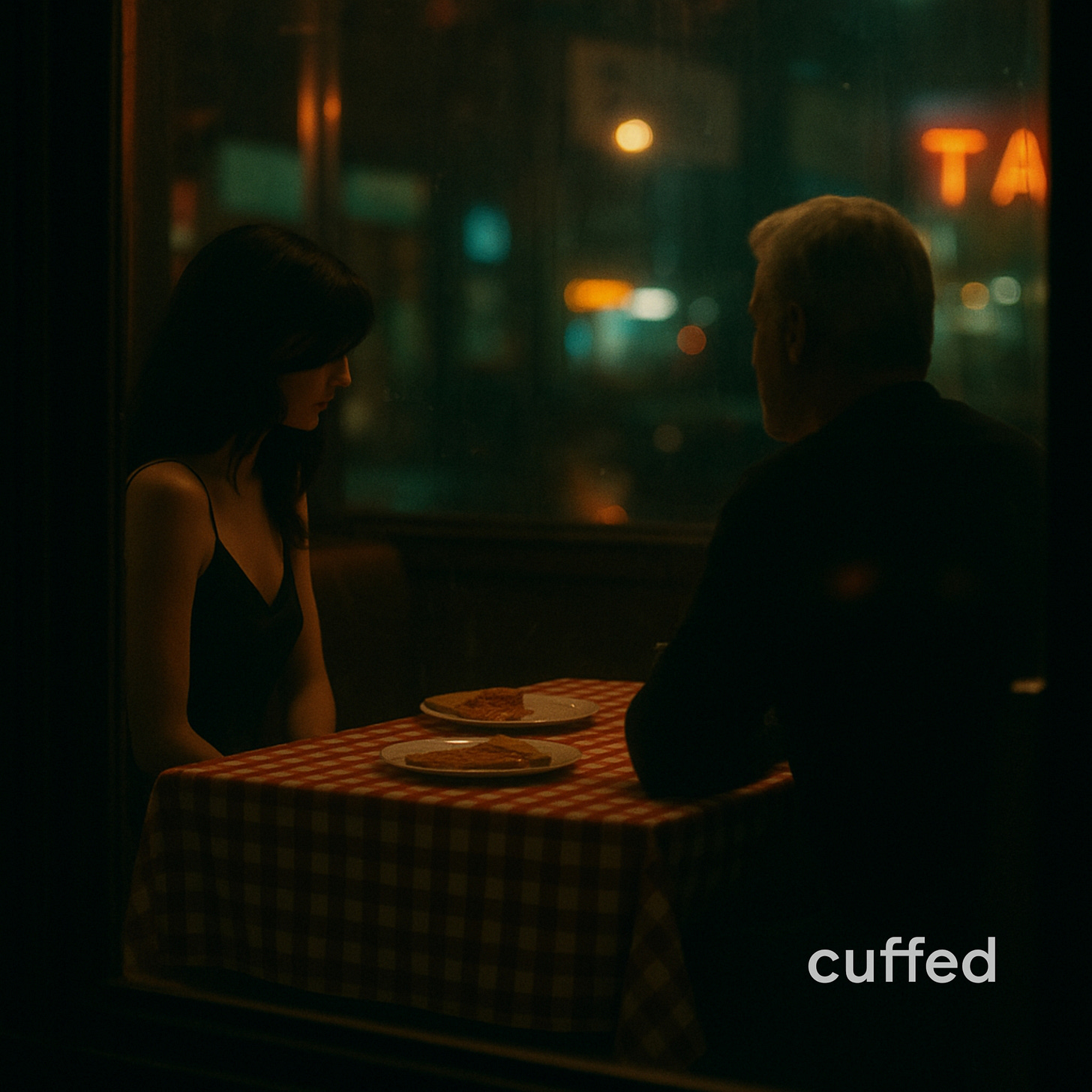 A man with silver hair sits across from a young woman in a dimly lit pizza diner, both quiet, their body language heavy with emotion. The red-checkered tablecloth and untouched pizza create a cinematic stillness. Visual for cuffed musing no. 6: “the pizza place revelation: what men will do to be fully themselves.”