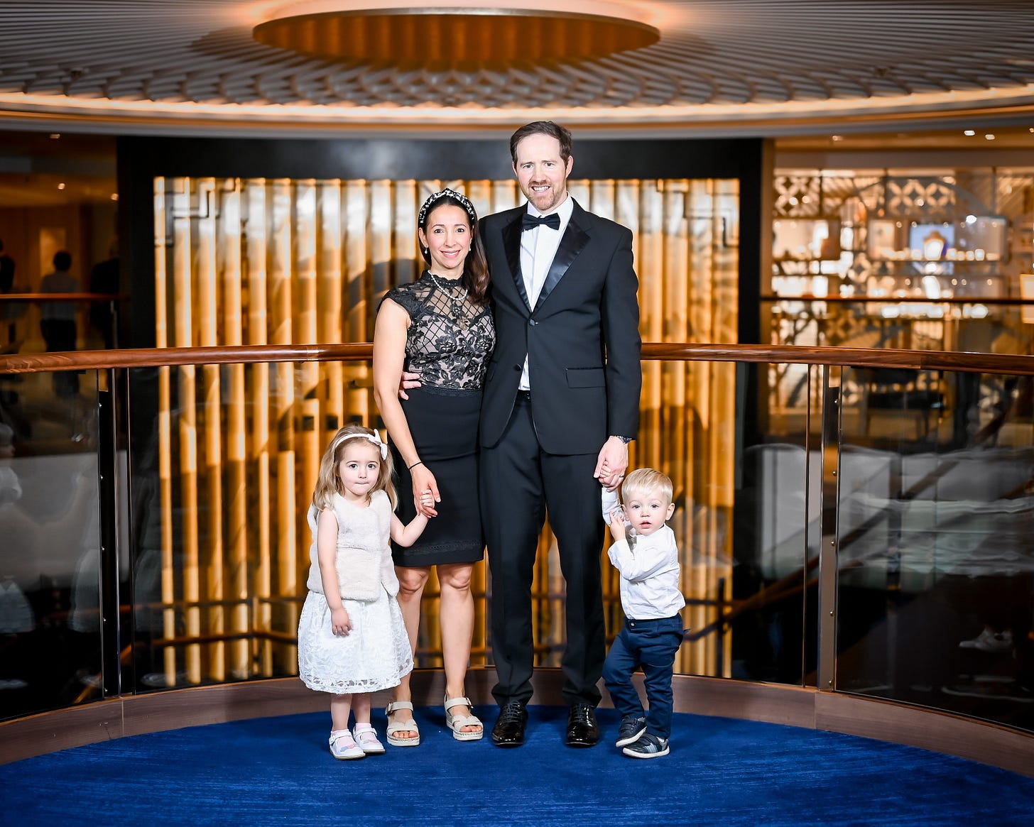 Laurence Loxam with his wife and two children dressed for dinner on a cruise, reflecting a moment of family time and stepping back from work to regain clarity and perspective.