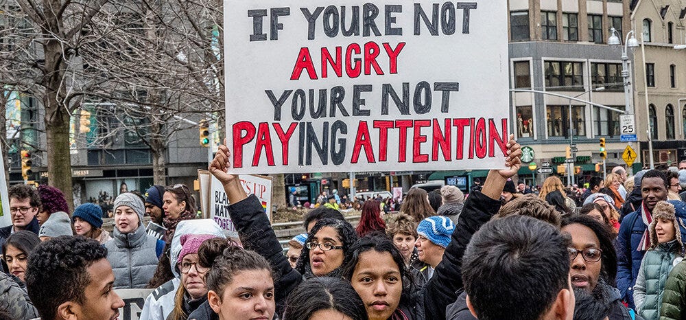 Photo from the Women's March featuring a protest sign that says If you're not angry you're not paying attention