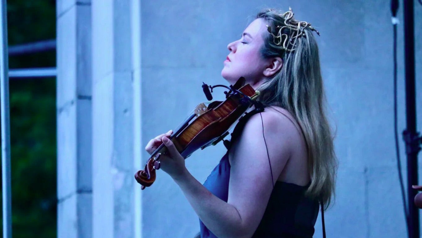 Photo of Lara St. John, violin in hand Photo of Lara St. John, violin in hand