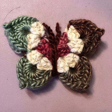 Nine multi-coloured crocheted butterflies