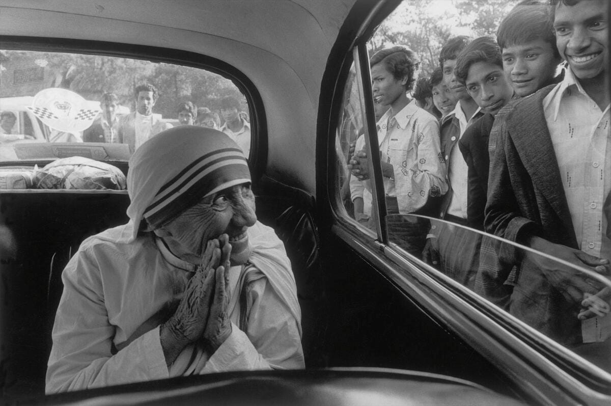 Mother Teresa being greeted during a visit to one of her missions. Shillong, India. 1989. © Raghu Rai / Magnum Photos