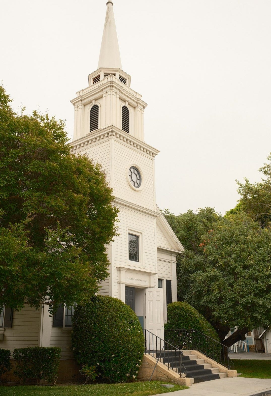 a church with a steeple and a clock on it